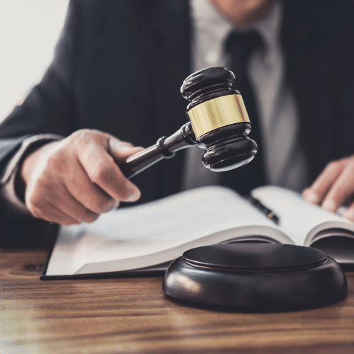 Judge using a gavel at a desk